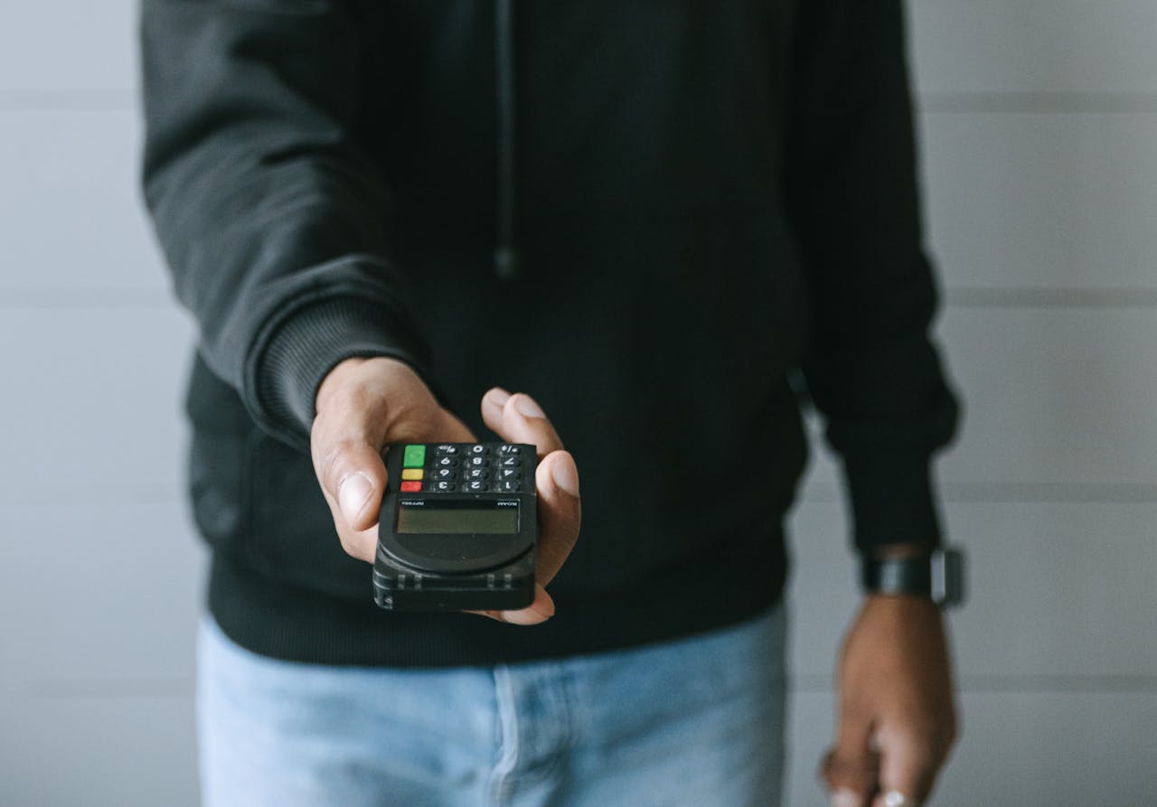 Person in Black Long Sleeve Shirt Holding Black Smartphone